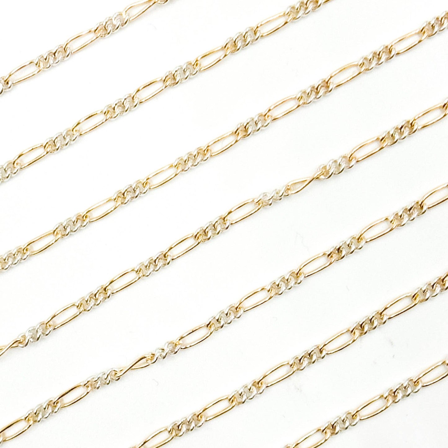 XM/2531CTT. 14k Gold Filled and Sterling Silver 1 Long and 3 Short Link Chain: 1 Ft. / 6.1mm-7mm / Figaro