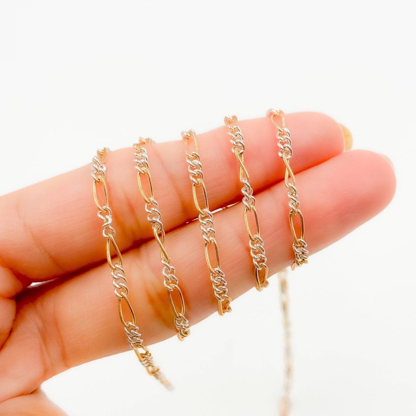 XM/2531CTT. 14k Gold Filled and Sterling Silver 1 Long and 3 Short Link Chain: 1 Ft. / 6.1mm-7mm / Figaro