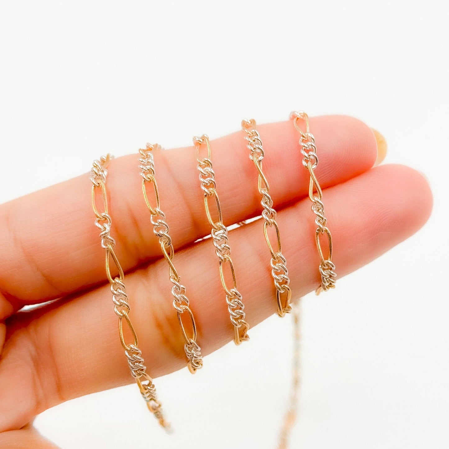 XM/2531CTT. 14k Gold Filled and Sterling Silver 1 Long and 3 Short Link Chain: 1 Ft. / 6.1mm-7mm / Figaro