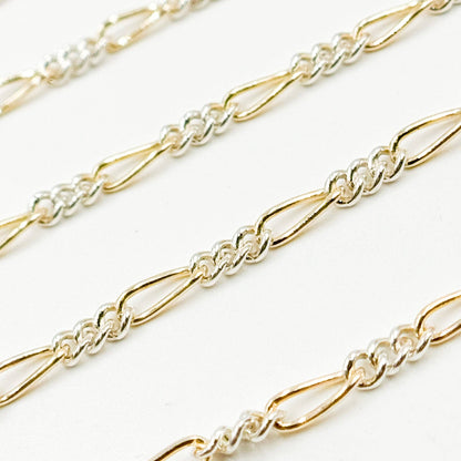 XM/2531CTT. 14k Gold Filled and Sterling Silver 1 Long and 3 Short Link Chain: 1 Ft. / 6.1mm-7mm / Figaro