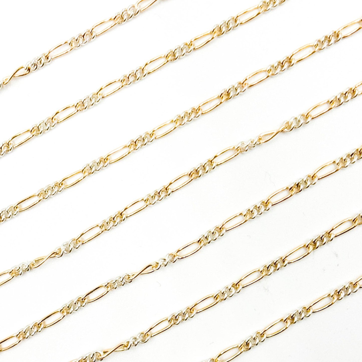 XM/2531CTT. 14k Gold Filled and Sterling Silver 1 Long and 3 Short Link Chain: 1 Ft. / 6.1mm-7mm / Figaro