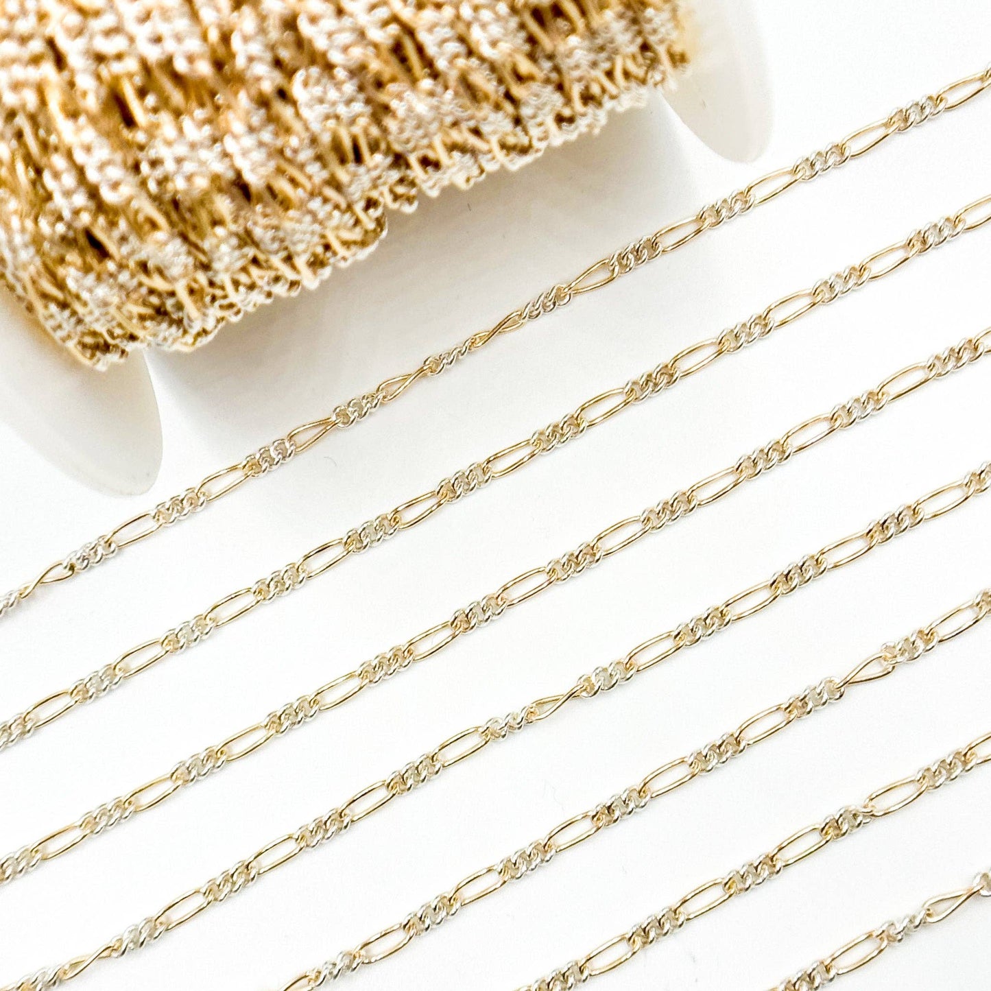 XM/2531CTT. 14k Gold Filled and Sterling Silver 1 Long and 3 Short Link Chain: 1 Ft. / 6.1mm-7mm / Figaro